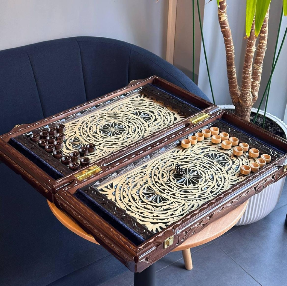 Intricately carved backgammon set, wooden board with geometric design, artisan-crafted luxury tabletop game at wholesale prices.
